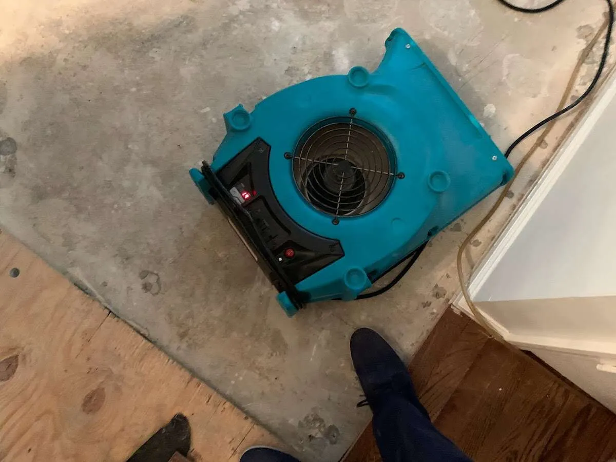 Air mover drying subfloor during Commercial Water Damage Restoration in Chillicothe
